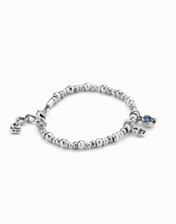 Pulsera bañada en plata de ley con perla y cristal azul.