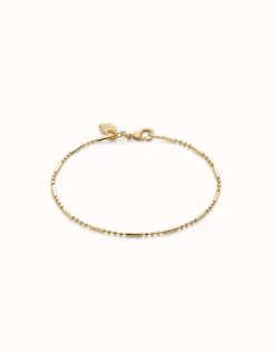 Pulsera con bolas y piezas alargadas bañada en oro 18k