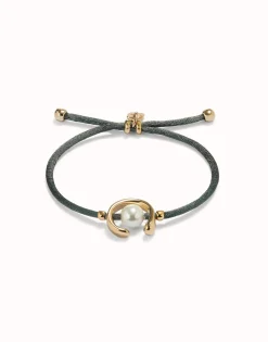 Pulsera de hilo negroso con perla shell fornitura bañada en oro 18k.