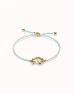 Pulsera de hilo verde azulado con perla shell fornitura bañada en oro 18k.