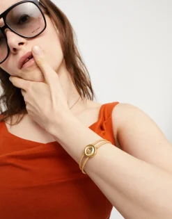 Pulsera doble de cuero crema con ojo bañado en oro 18k