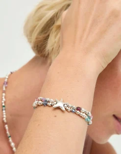 Pulsera elástica bañada en plata con cristales facetados y estrella de mar